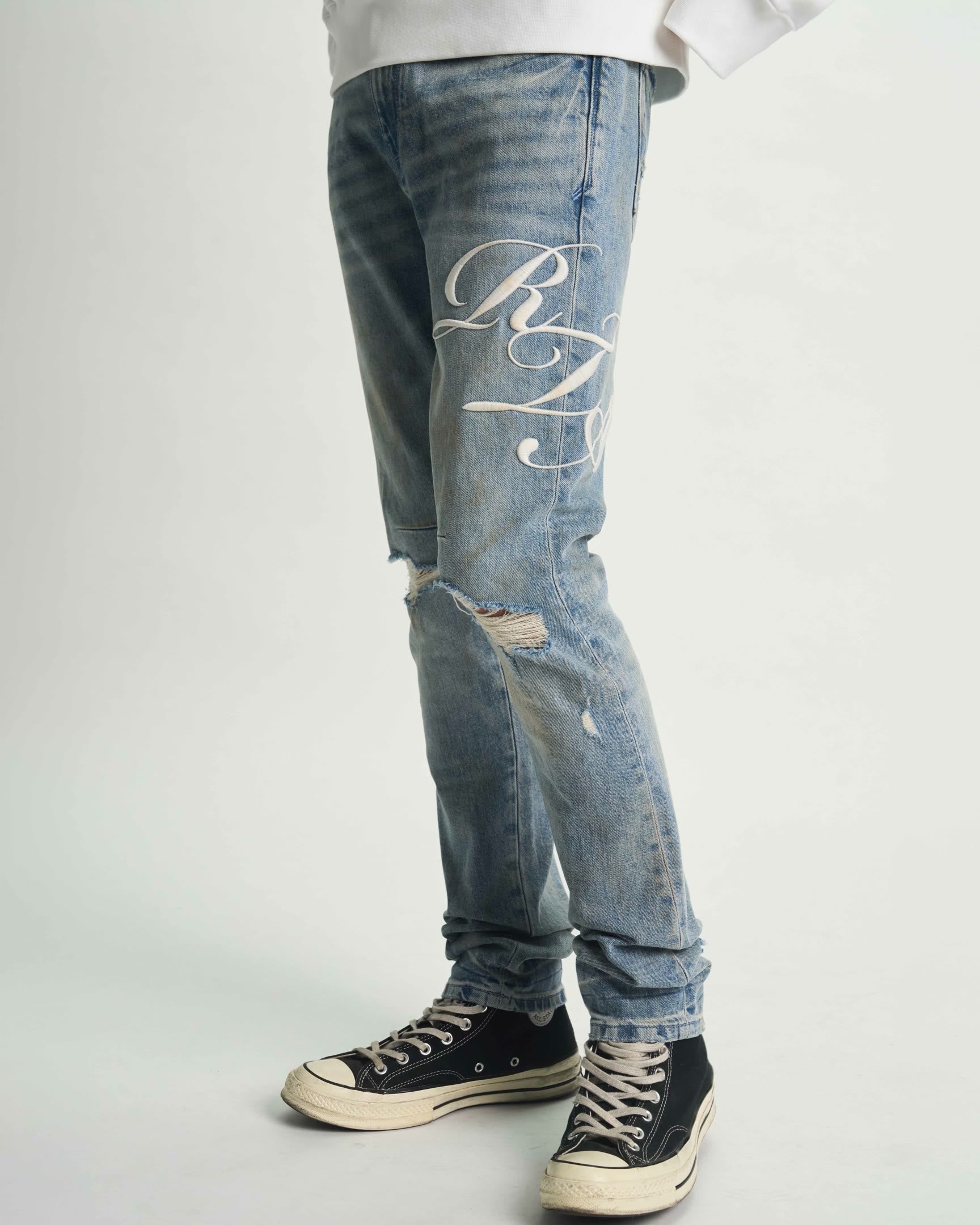 Light Blue Distressed Skinny Jeans with Cursive Graphics - Side Styled Detail | RTA