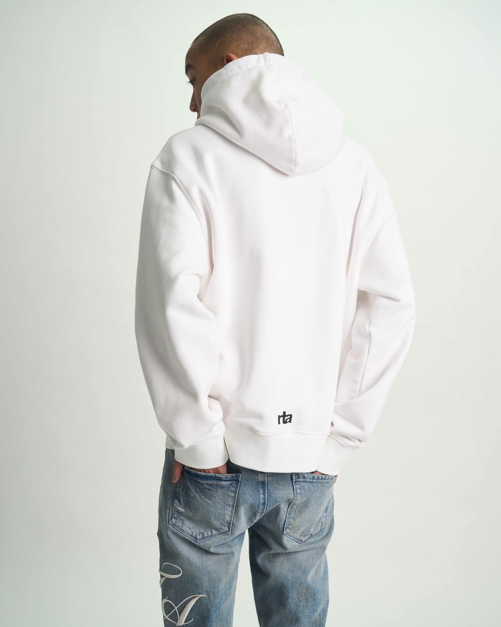 White Dion Streetwear Hoodie with RTA Logo at Hem - On Model Back View | RTA