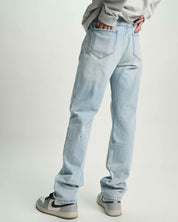 Light Blue Distressed Denim Slim Jean - On Model Back View with Logo Detail | RTA