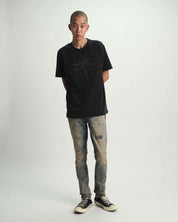 Black RTA Thorn Graphic Tee On Model, Full Body Front View, Styled with Distressed Denim | RTA