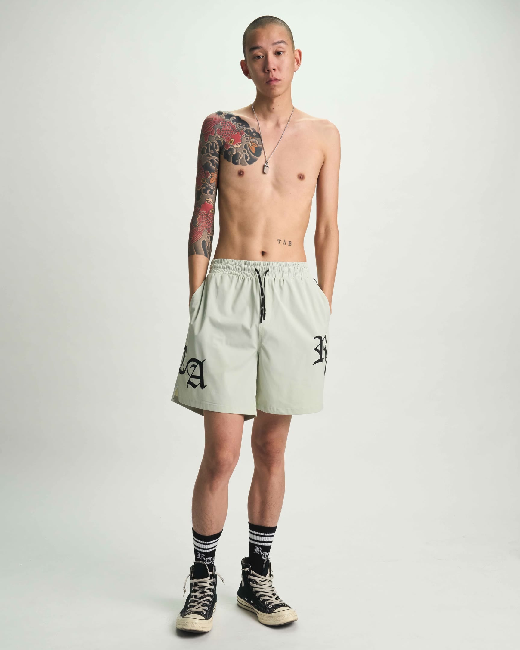 Light Teal Mark Swim Trunks with Gothic Branding - On Model Front | RTA