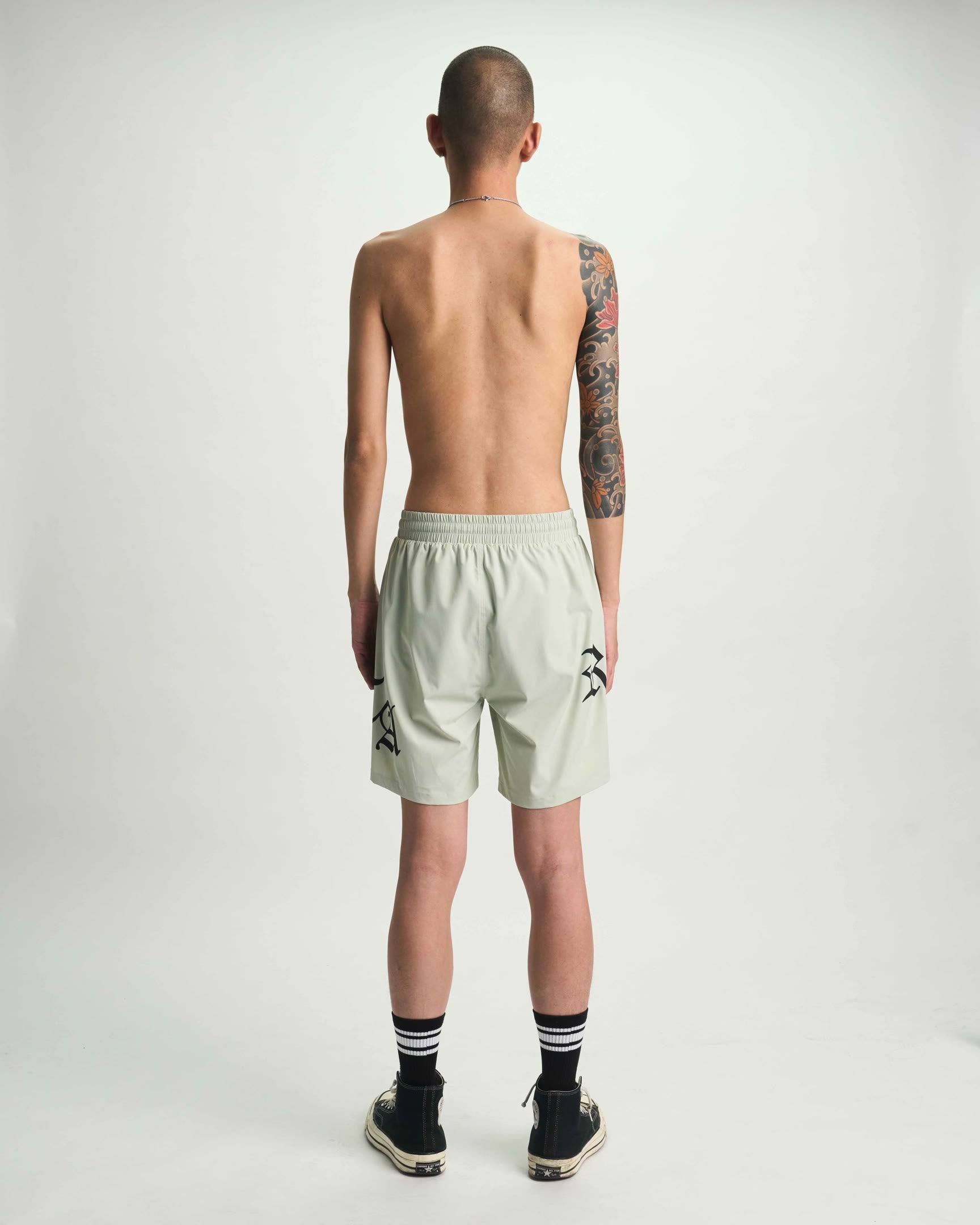 Light Teal Designer Swim Shorts with Old English Graphics - Model Back | RTA