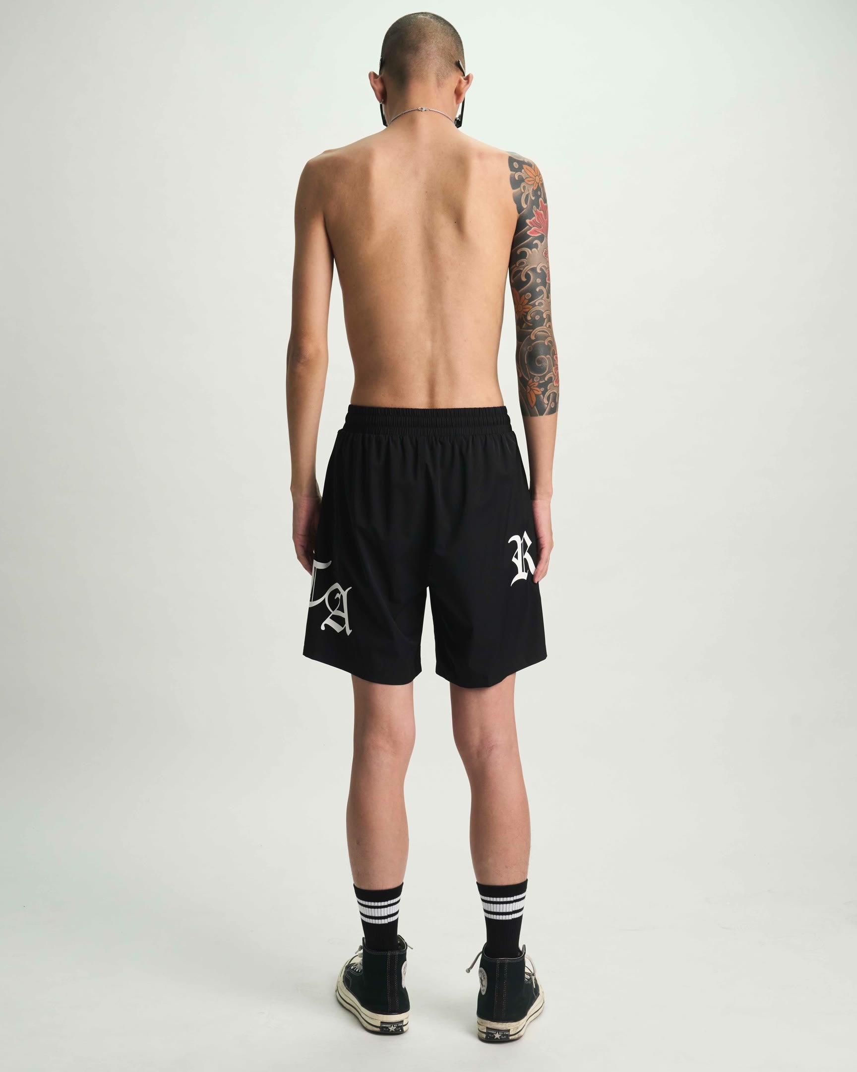 Black Old English RTA Swim Trunks - Back View On Model | RTA