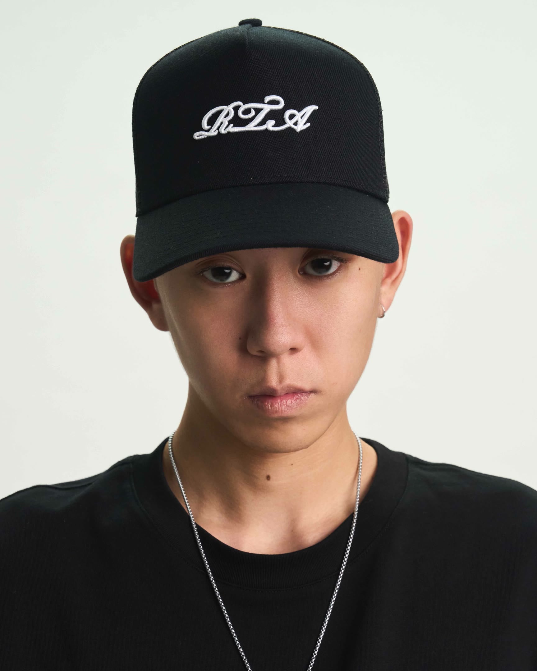 Black Gideon Trucker Hat Styled on Model - Streetwear Look | RTA