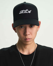 Black Gideon Trucker Hat Styled on Model - Streetwear Look | RTA