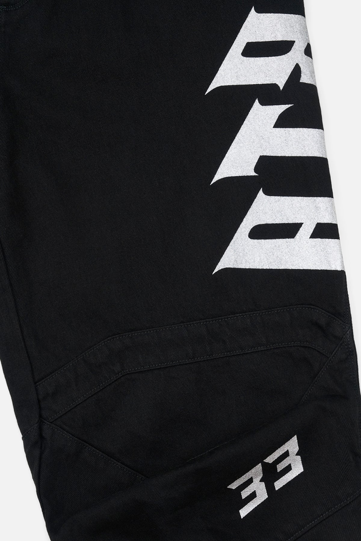 Black Alwin Moto Jean - Graphic Close-Up, Old English Logo and Moto Panel Detail | RTA