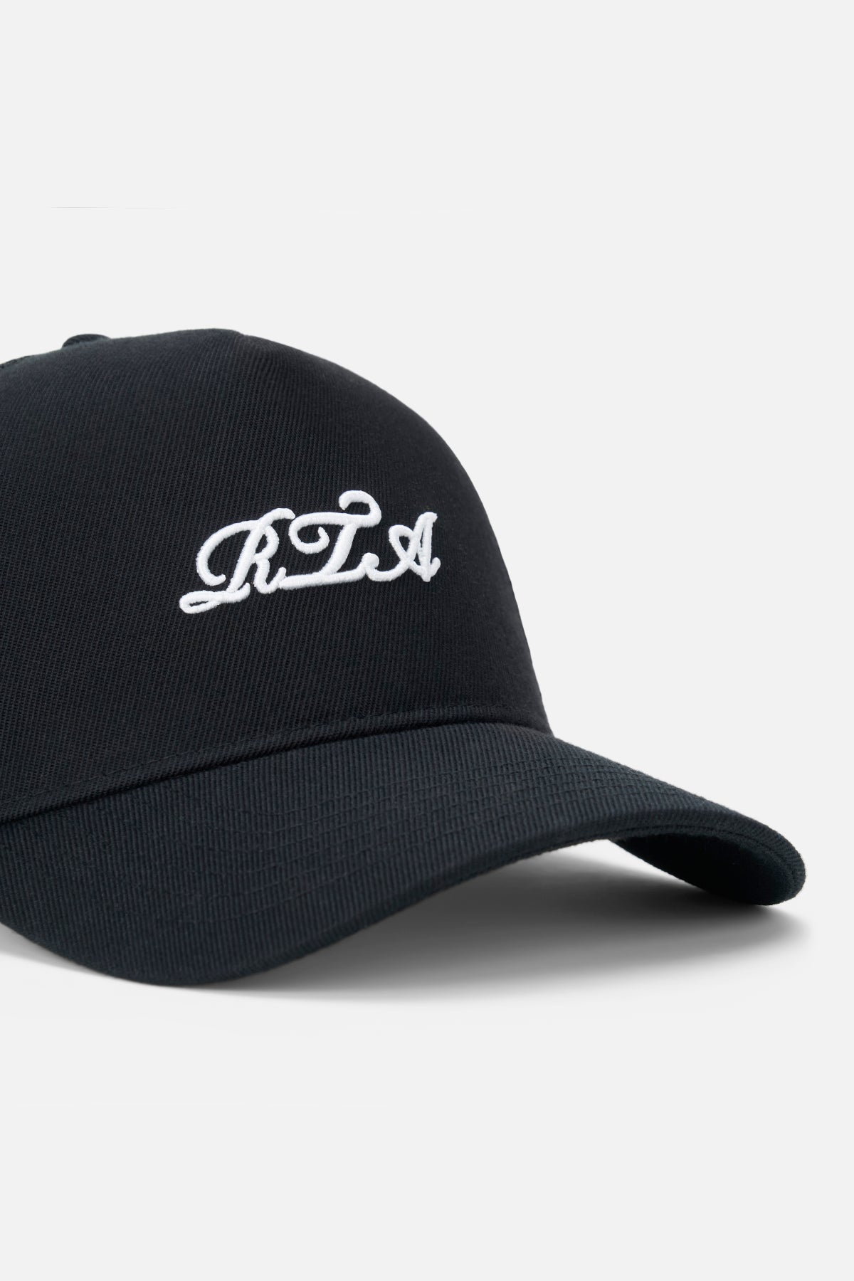 White Cursive RTA Embroidery Detail on Black Hat - Close Up | RTA