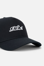 White Cursive RTA Embroidery Detail on Black Hat - Close Up | RTA