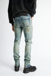 RTA Bryant Skinny Jean Indigo Rust - On Model Back View, Rust-Tinted Distressed Denim | RTA