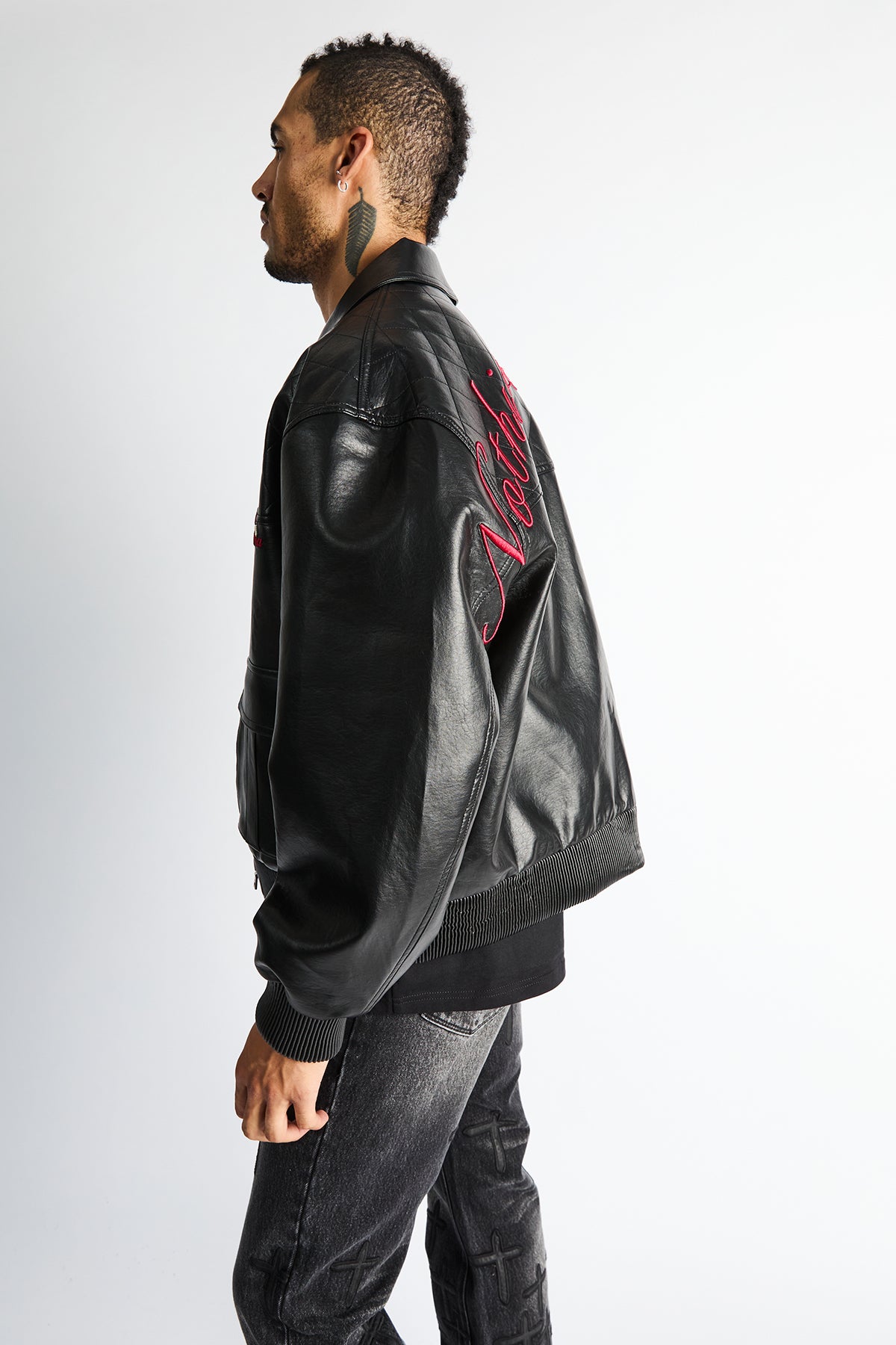 RTA Evander Oversized Bomber Black - Side Profile, Red Script Detailing, Oversized Silhouette On Model | RTA