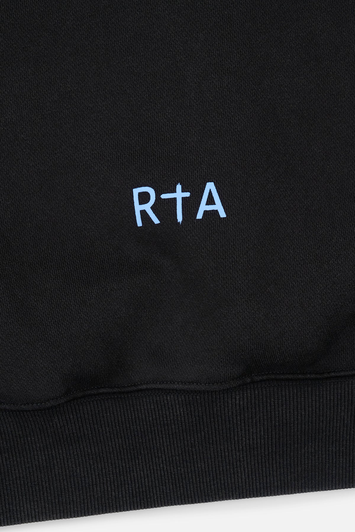 Sairen Cropped Boxy Hoodie Black Curva Ultra - Close-Up RTA Cross Logo Hem Detail | RTA