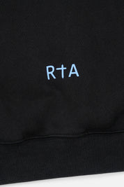 Sairen Cropped Boxy Hoodie Black Curva Ultra - Close-Up RTA Cross Logo Hem Detail | RTA