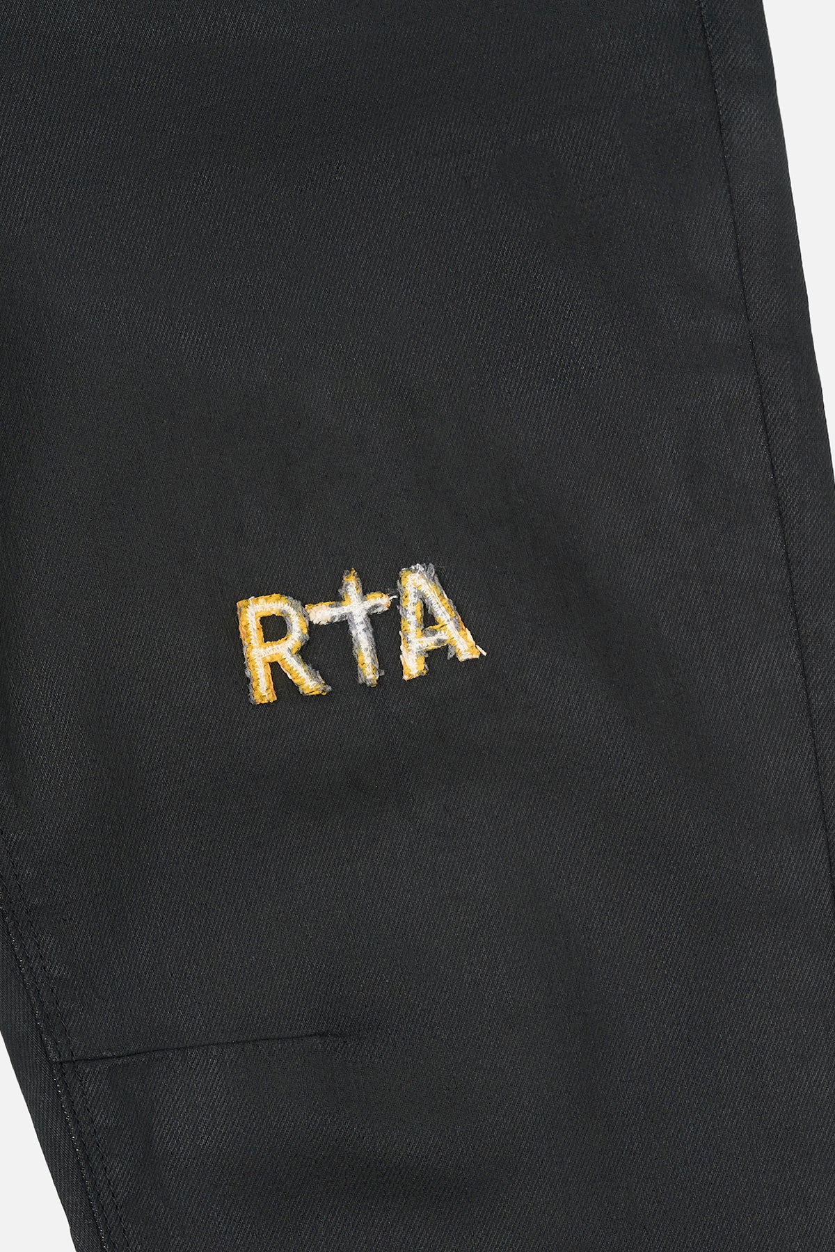 Black Denim Skinny Jean Yellow Cross Patch Logo Close-Up Detail | RTA