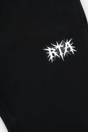 RTA Spike Logo Detail on Black Cotton Sweatpants - Close Up | RTA