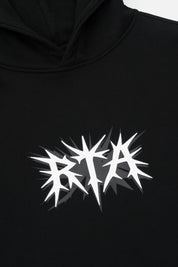 White Spike RTA Logo Detail on Black Cotton Hoodie - Chest Close-up | RTA